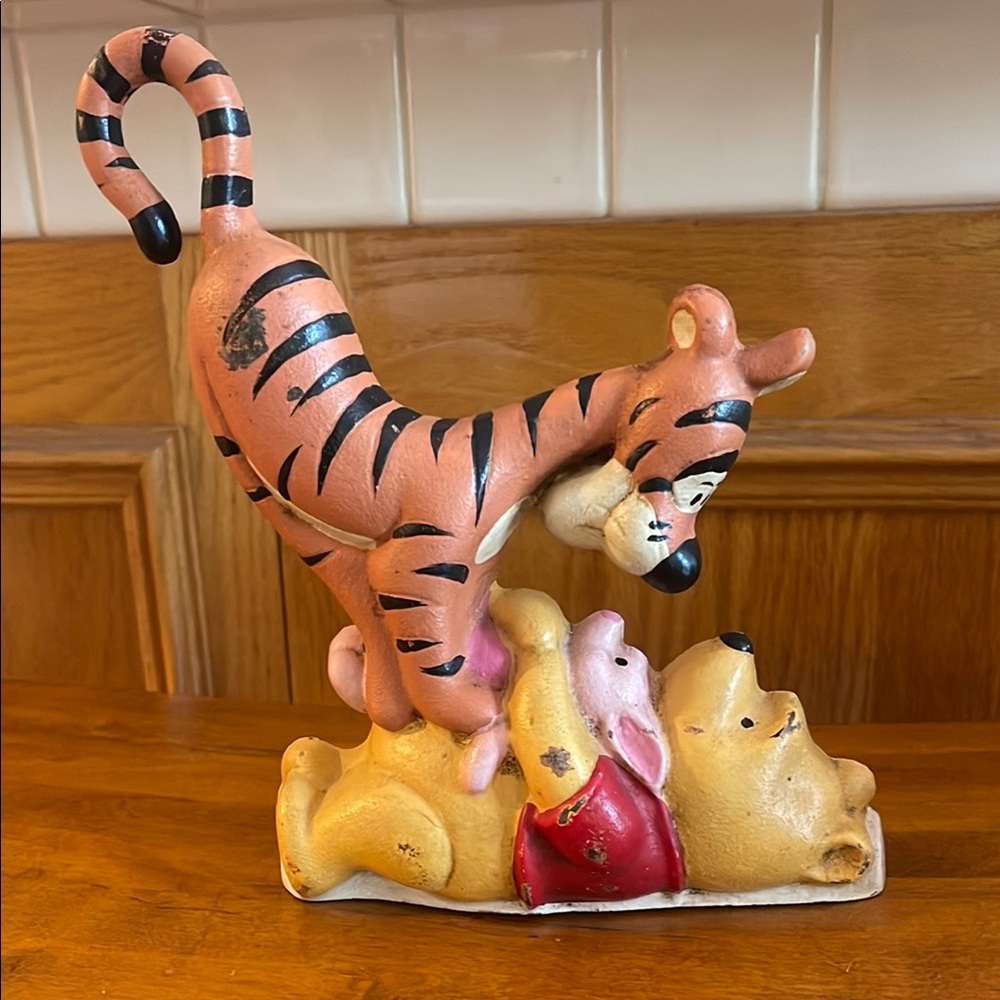 Vintage Disney cast iron doorstop featuring Winnie the Pooh, Tigger, and Piglet